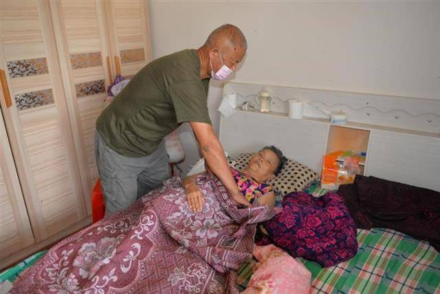 陈店乡同兴村五保老人刘叔广正在照顾瘫痪在床的妻子