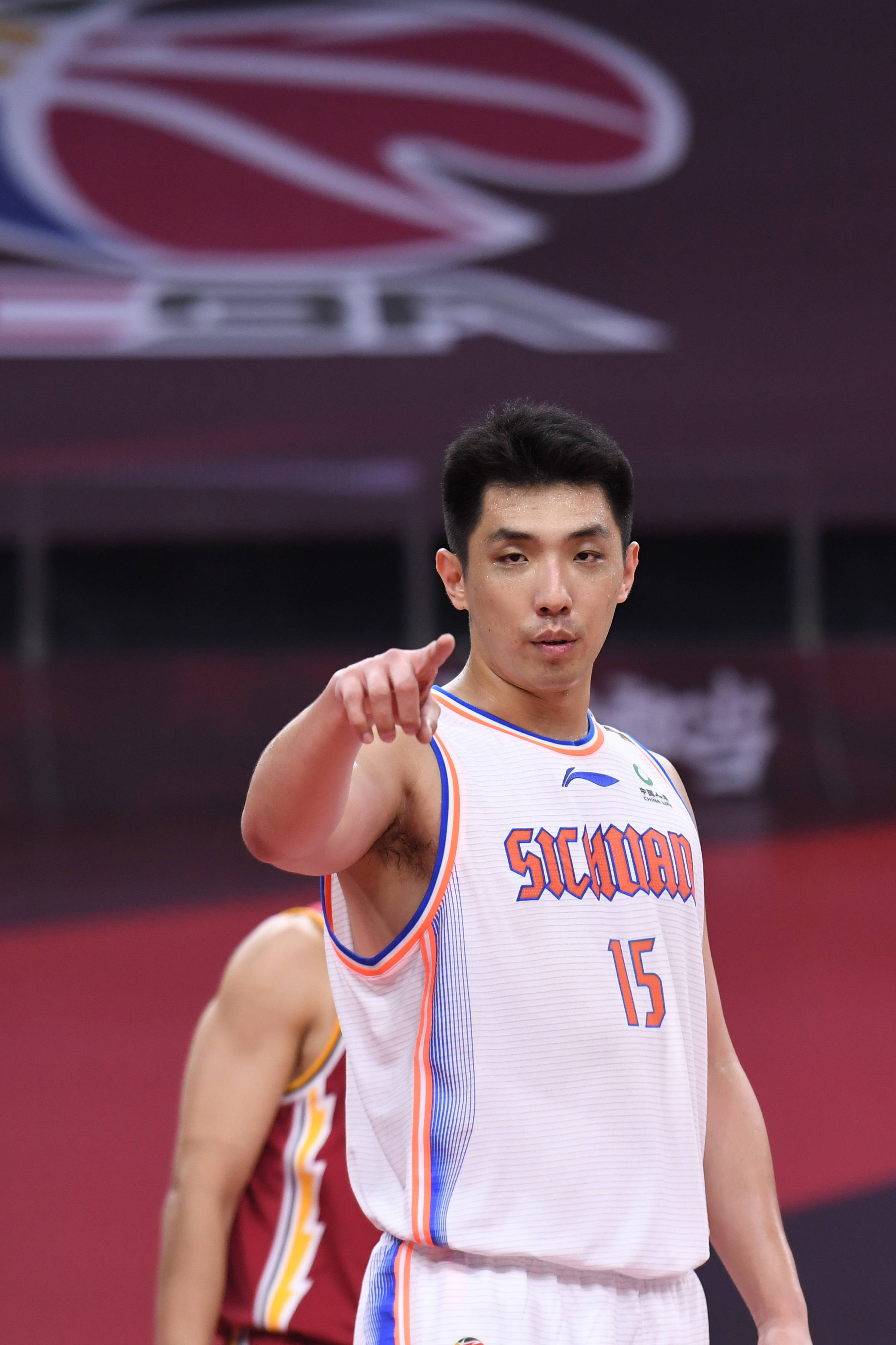 6月24日,四川五粮金樽队球员李原宇(前)在比赛中与队友交流.