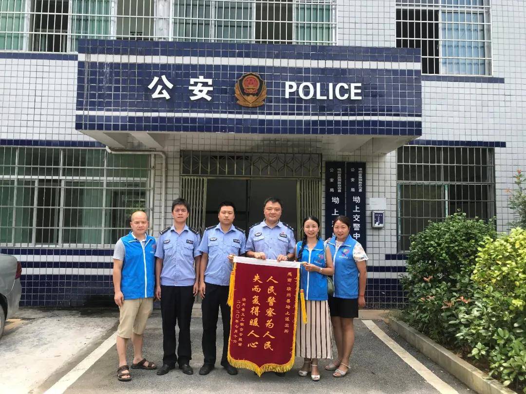 7月21日靖州县义工联合会李昀桦会长手持两面书有"人民警察为人民 失