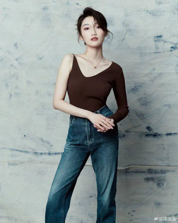 冷天爱身穿一袭棕色吊带上衣,她俏脸成熟冷艳,眼神犀