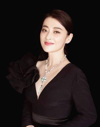 拉长了整体的腰线和身高;下身选择蕾丝材质的短裤,把梅婷的白皙大长腿