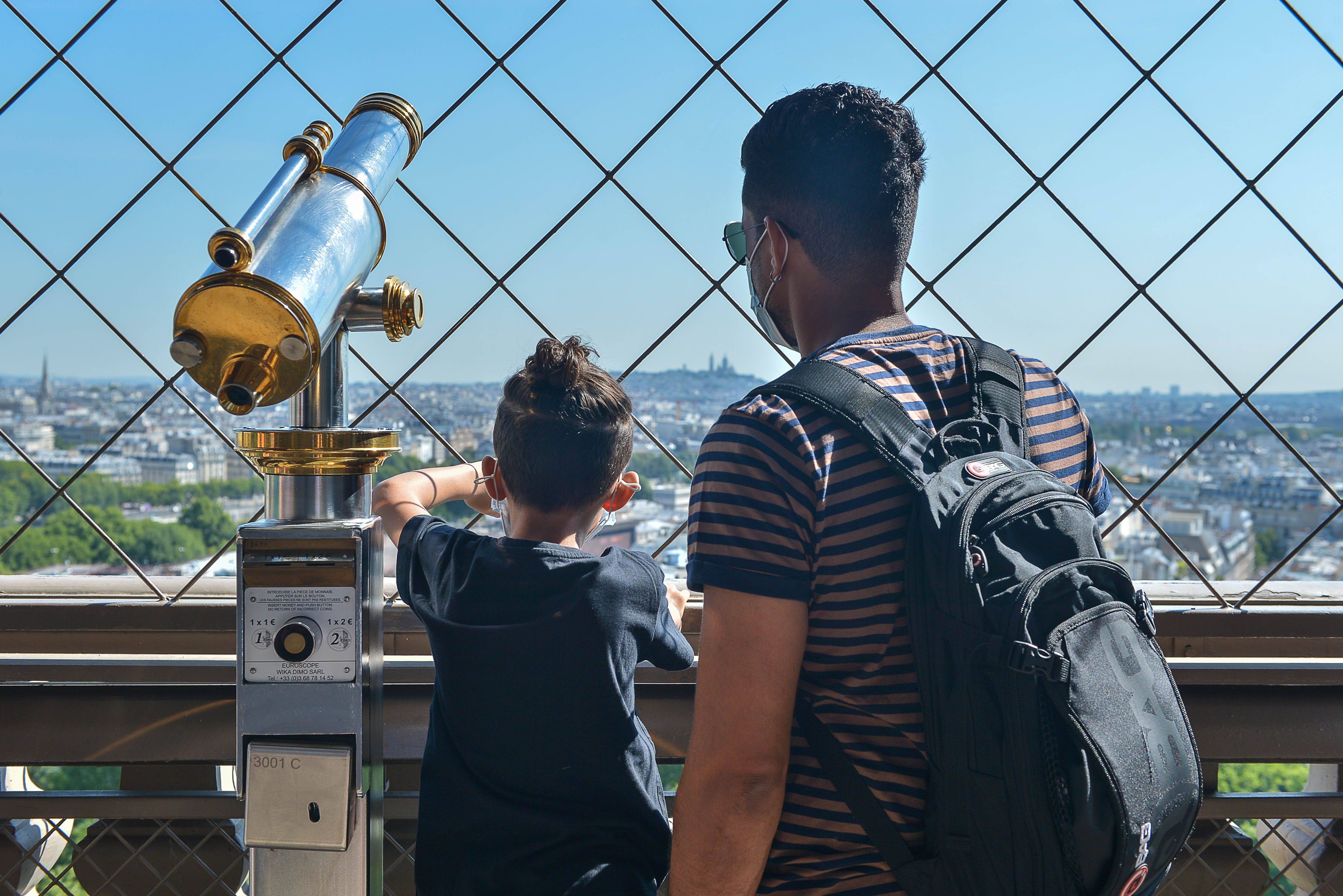 6月25日,游客在法国巴黎埃菲尔铁塔上鸟瞰巴黎城景.