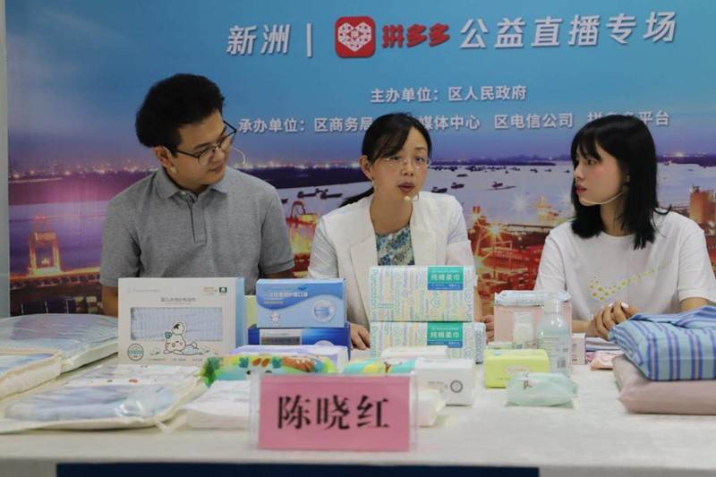新洲区政府副区长陈晓红(中)向拼多多用户推荐当地产品.