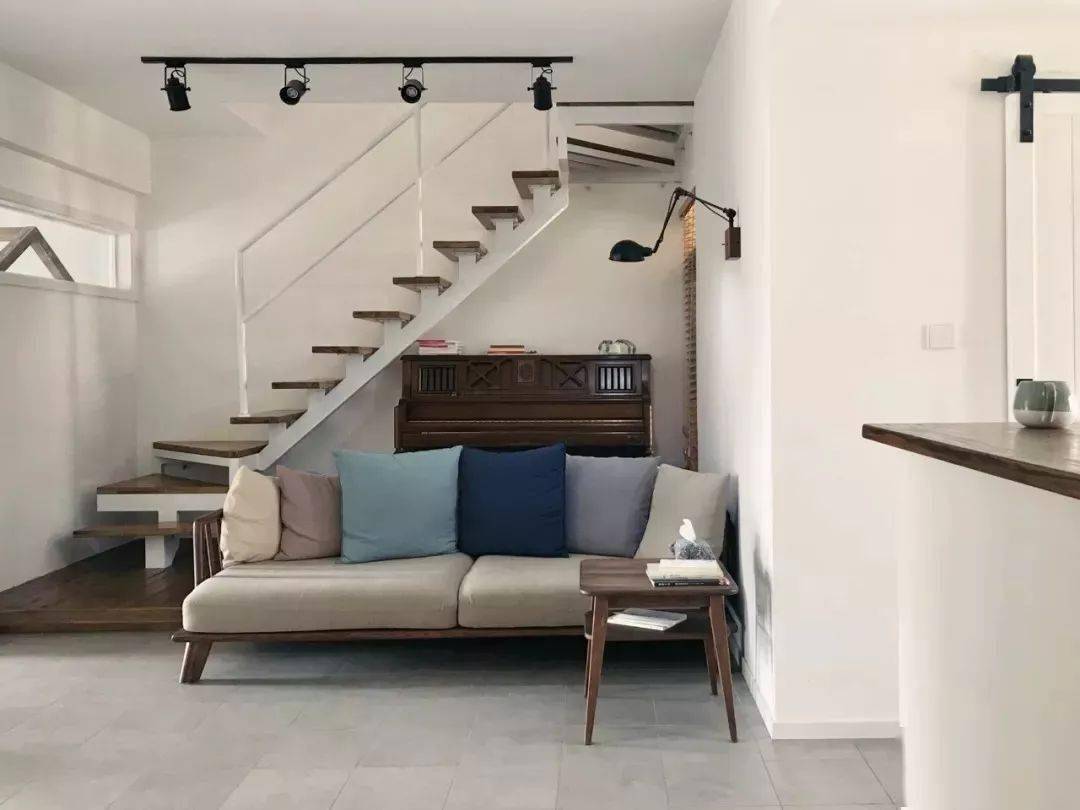 复式户型的屋主来说,推荐你把楼梯下方的空间用来摆放沙发,沙发和楼梯