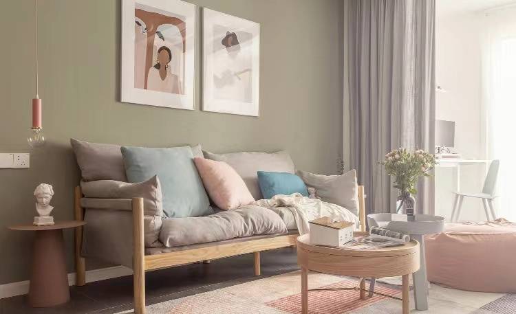 沙发的背景墙采用了灰绿色安静柔和的色彩,让空间舒适自然